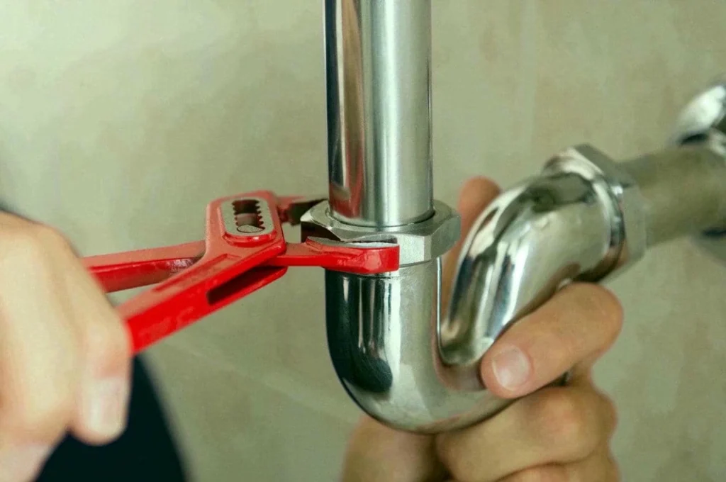 Plumber's Fixing Pipe Lock With Wrench