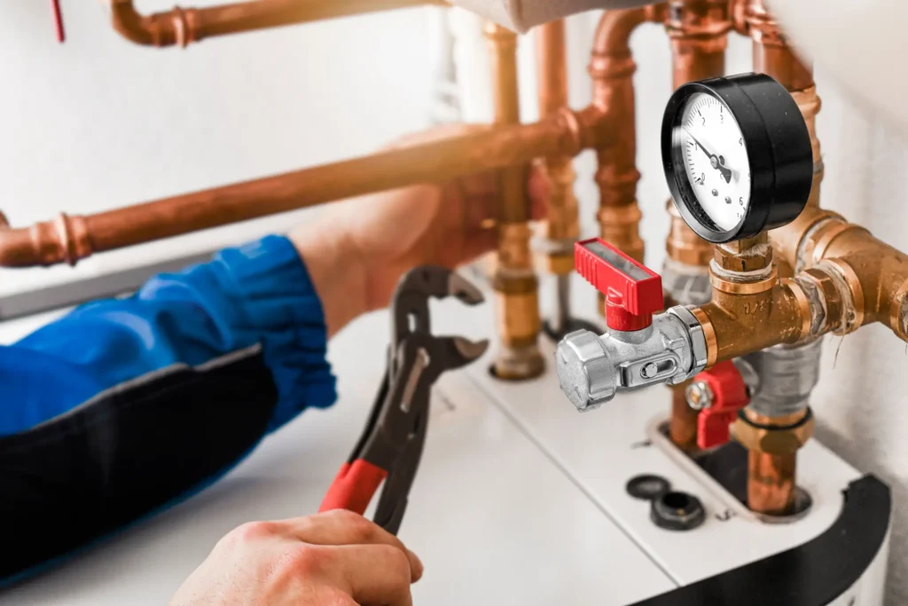 Plumbing system maintenance showing copper pipes, pressure gauge, and shut-off valve in home water supply