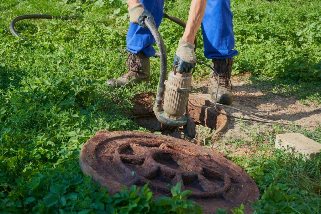 Plumber inspecting sump pump for repair