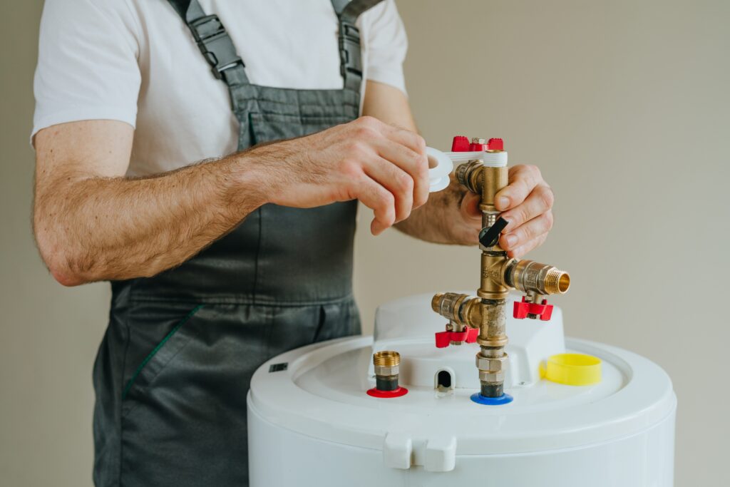 Plumber repairing residential water heater