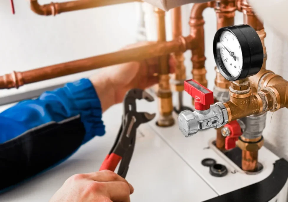 Plumbing system maintenance showing copper pipes, pressure gauge, and shut-off valve in home water supply