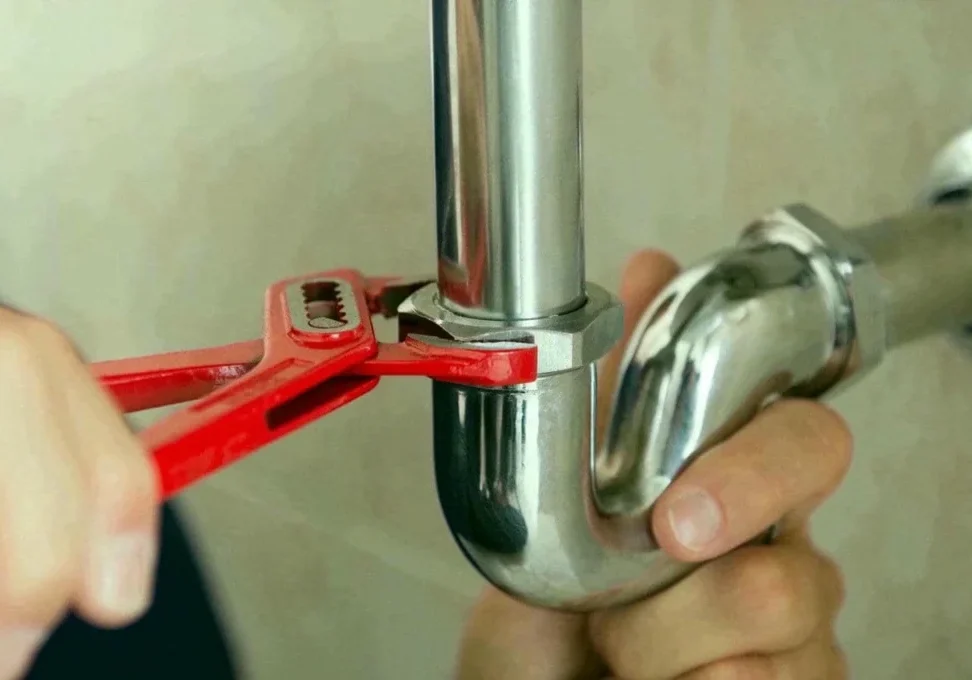 Plumber's Fixing Pipe Lock With Wrench