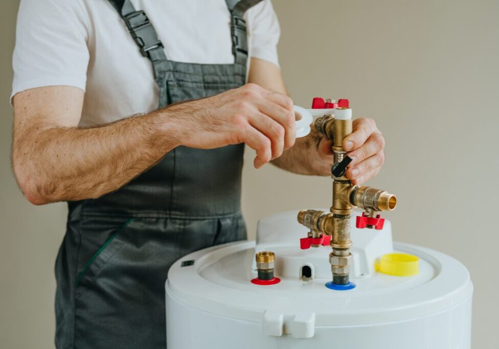 Plumber repairing residential water heater